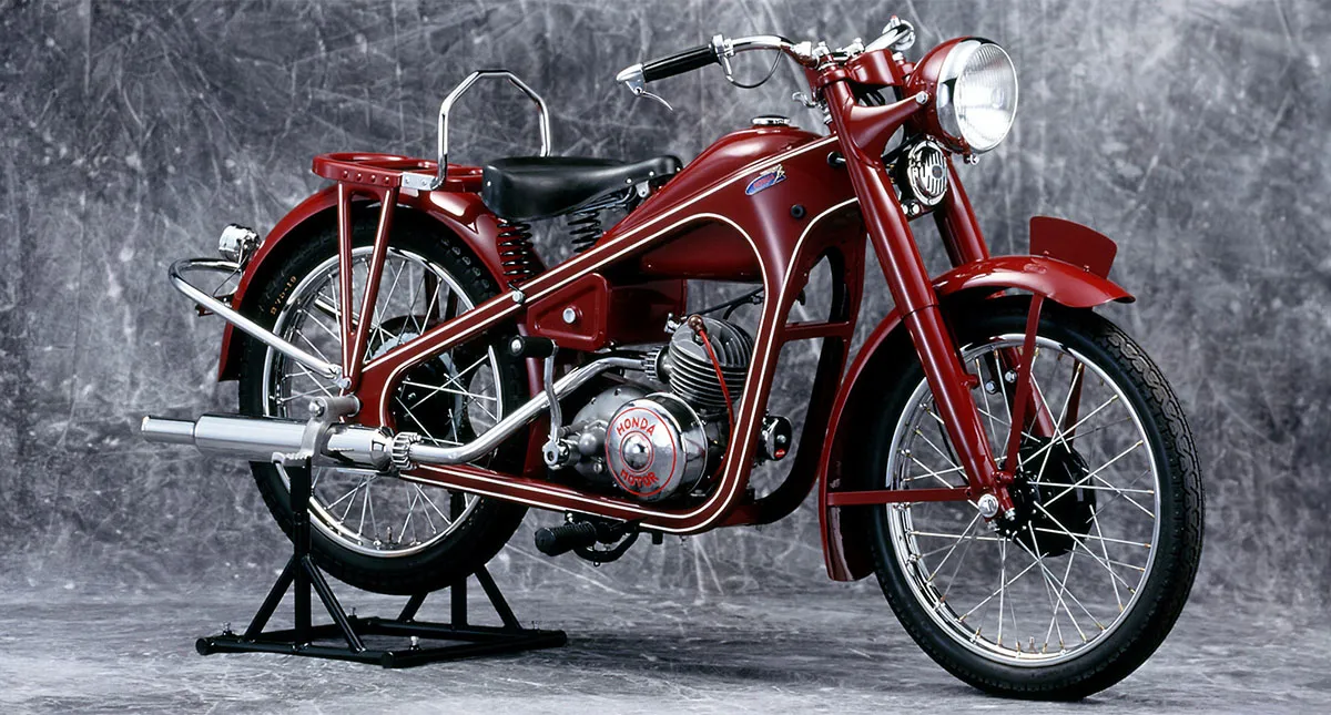  Imagem da motocicleta Honda Dream D-Type, a primeira motocicleta da marca, exibida em um fundo neutro.
