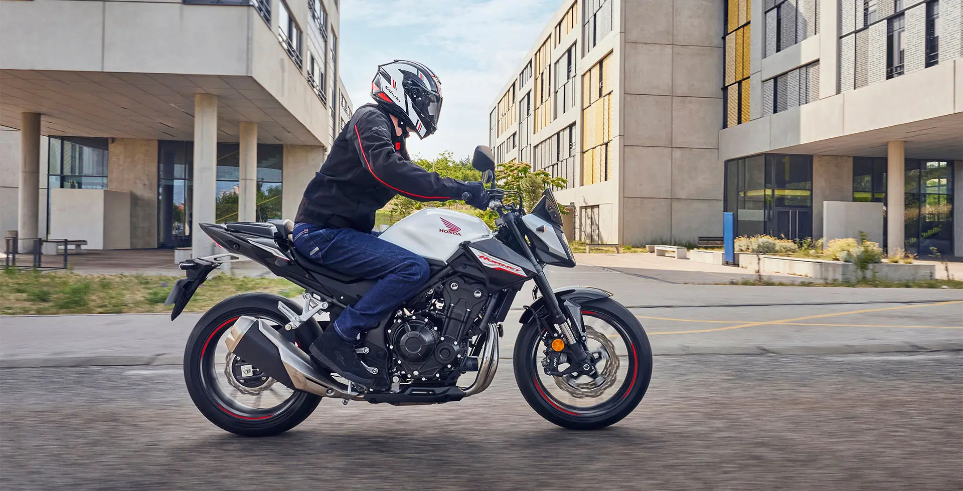 Homem pilotando Hornet 500 com prédios ao fundo