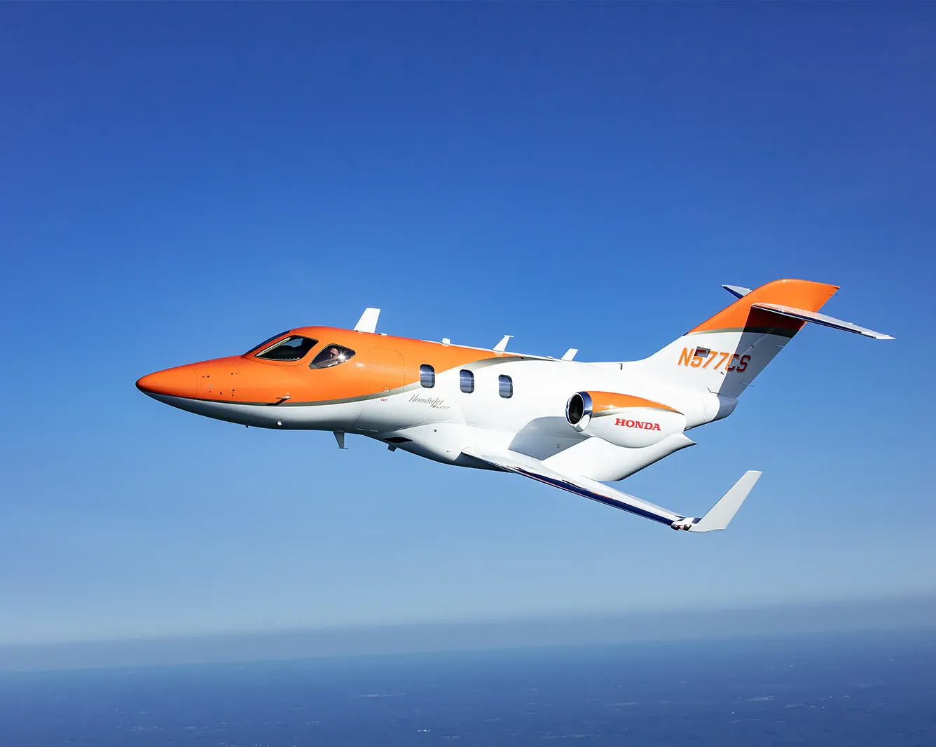 Avião da Empresa Honda Voando no Céu Azul