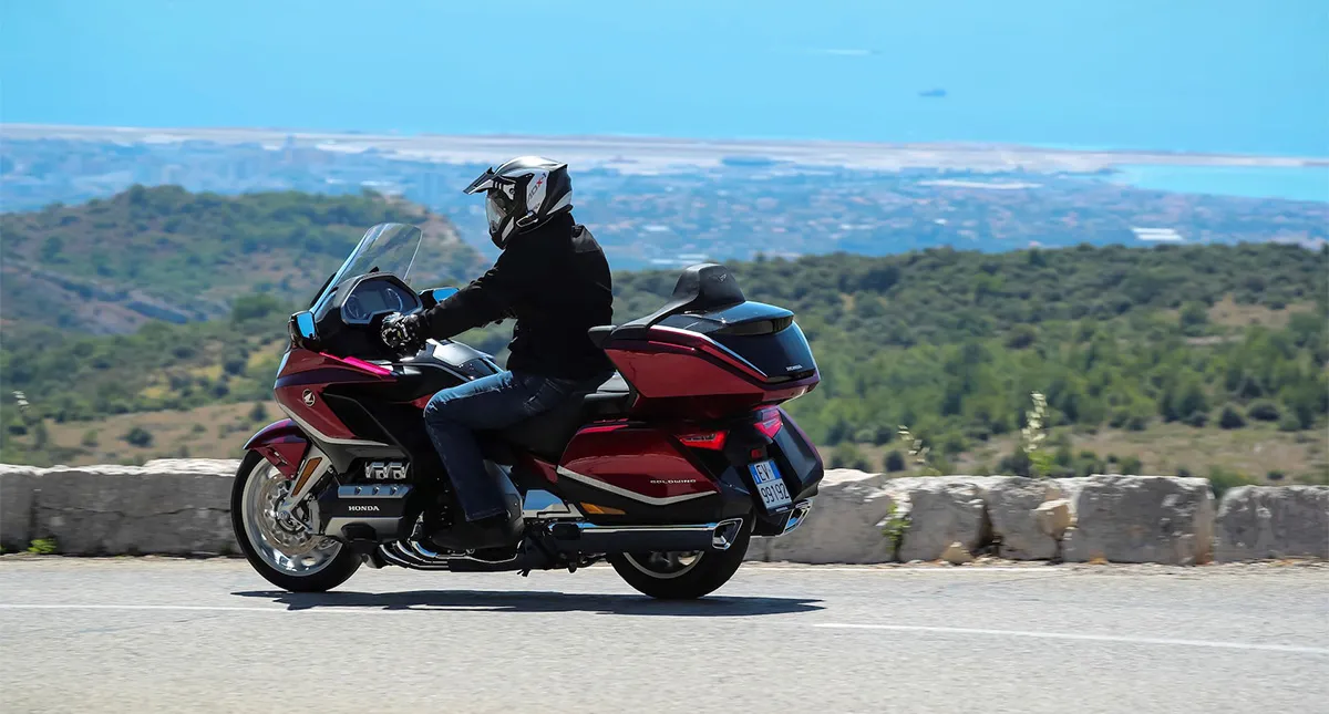 Piloto na estrada em sua Moto Honda GL 1800 Gold Wing Tour vermelha